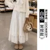 Falda midi de felpa blanca para mujer, nueva falda larga acampanada de línea A de cintura alta para otoño/invierno 2026 con caída fluida y diseño de falda pastel de encaje