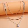 Joyería transfronteriza europea y americana, con un elegante collar de gota de agua con nicho de metal, estilo viento frío y diamantes de imitación superpuestos.
