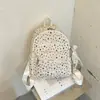 Mochila com estampa de estrelas, grande capacidade, simples e versátil, adequada para estudantes, estilo coreano, com estampas de letras e um visual preppy de faculdade.
