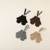 Diseño simple se refiere a guantes de punto para niños, guantes de lana de una sola capa cálidos de invierno, manoplas de estilo colgante para bebé con correa para el cuello