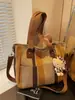 Bolsa Feminina de Comércio Exterior 2025 Nova Moda Bolsa de Lona Listrada Grande Capacidade Bolsa de Ombro Portátil para o Dia a Dia Bolsa Tote Transversal
