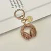Llavero de Audífonos con Pedrería de Cristal Llavero Musical Completamente Cubierto de Pedrería Adorno Colgante de Cuerda de Diamante para Bolso Accesorios Llavero de Coche