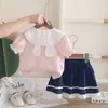 Conjunto de falda corta para niña, nueva colección de verano 2026, elegante y lindo, con cuello de conejo y manga corta, un conjunto de dos piezas de moda
