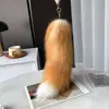 Cola de zorro de piel auténtica para llavero, colgante de bolso, accesorios para utilería de escenario, cosplay de piel auténtica