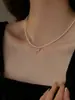 Estilo todo con collar colgante de corazón de mariposa de perla cadena de clavícula de perla pequeña para bebé cadena de suéter de moda de lujo ligero