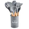 Punho de madeira Silicone Utensílios de cozinha Conjunto de 12 peças Antiaderente Pan Barril de armazenamento Utensílios de cozinha Espátula Colher de fritura Colher de sopa Escorredor Clipe de comida