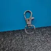 Fabricante de hebillas para perros al por mayor, ganchos para mascotas de aleación de zinc, hebillas de placa de resorte para bolsas de ferretería y ganchos en forma de oliva grandes y pequeños en stock