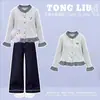 Conjunto de dos piezas para niñas de principios de otoño 2026: top de moda estilo coreano con retazos de cuadros y pantalones vaqueros anchos versátiles