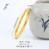 Mismo estilo que Puzuo Gold Shop pulsera de círculo liso con espalda de locha dorada brillante para mujer simple sensación de alta gama pulsera sólida anillo de mano de boda