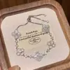Pulsera de flor de trébol de cuatro hojas para mujer, lujo ligero, sensación de alta gama, circonita cúbica, cordón ajustable, exquisita, dulce, joyería de mano versátil