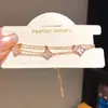 Pulsera con colgante de flor de trébol de nácar de doble capa, sensación de lujo ligero y alta gama, accesorio de mano elegante y versátil