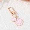 Llavero de cara sonriente transfronterizo aleación gotas de aceite coloridas oro expresión irregular accesorios colgantes para bolso universal