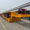 Venda transfronteiriça de semirreboque de plataforma baixa hidráulico com pescoço de ganso de 4 eixos, trailer de transporte de equipamentos de engenharia pesado de 100 toneladas