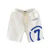 Verano 2023 nuevos shorts blancos estampados marca de moda para hombre pantalones deportivos holgados de cinco puntos pantalones de viaje para hombre Pantalones de playa