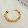 Novo bracelete de moda transfronteiriça trançado oco espesso aberto torcido europeu e americano mais vendido para homens e mulheres