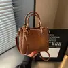 Bolso tejido de PU de alta gama para mujer, nuevo modelo 2026, bolso tipo cubo simple, bolso de hombro de moda de gran capacidad, bolso cruzado