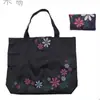 Fábrica para bolsa de mano impermeable de tela Oxford para regalos, bolsa de compras plegable de moda colorida con flores, bolsa de almacenamiento de protección ambiental portátil