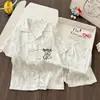 Venta al por mayor del fabricante en stock pijamas para niñas, ropa de casa para niños, conjunto de pijama de manga corta tipo cárdigan de seda helada de dibujos animados para verano