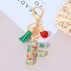 Llavero de Letra Inglesa de Resina Serie Navideña con Borla Colgante para Bolso Unisex Regalo de Fiesta Navideña