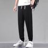 Pantalones casuales delgados de verano de seda de hielo para hombre, pantalones holgados, marca de moda, transpirables, de nueve puntos, color sólido, pantalones largos para hombre