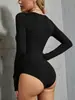 Moda femenina transfronteriza europea y americana nueva Otoño/Invierno 2026: body sexy y elegante de una pieza ajustado con escote asimétrico y color liso