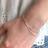 Pulsera de hueso de serpiente con cuentas plateadas de doble capa, estilo minimalista coreano, versátil para el uso diario, exquisitamente diseñada y con un toque sofisticado y de alta gama; venta al por mayor de cadenas delicadas