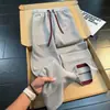Calça casual de blocos de cor texturizada estilo americano para homens, fina para o outono, com múltiplos bolsos, respirável, perna reta, solta, perna larga