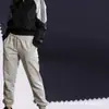 Tejido elástico liso de poliéster reciclado 50D para ropa deportiva, pantalones casuales, tejido tejido.
