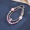Nuevo colgante de teléfono de doble cadena con un toque de alta gama, cuentas luminosas de flor de cerezo, correa de muñeca para teléfono, charm para bolso, pequeño regalo para mujeres