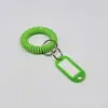 Venta al por mayor de fabricantes pulsera de resorte de plástico para línea telefónica marca de mano para sauna anillo retráctil pulsera cuerda de resorte almacenamiento anillo QQ