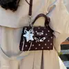 Bolso Kelly nuevo y versátil para mujer 2026, lujo ligero, moderno, de nicho, cuadrado pequeño, para ir al trabajo, bolso de mano de lunares