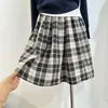 Textura a cuadros retro 100% algodón brote cintura media-baja línea A falda midi diseño con sentido académico estilo académico falda midi plisada mujer