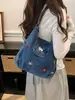 Bolsa de mezclilla multifuncional bordada con cachorro lindo 2026 nueva mochila/bolso de hombro casual de nicho de moda