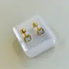 Aretes Mini Gota de Aceite Dorados de Acero de Titanio en Caja Aretes Sencillos de Tornillo Cuatro Hojas Pendientes de Marca Grande