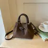 Bolso vintage de nicho súper popular para mujer, nuevo bolso cruzado versátil de otoño 2026, bolso de mano de cubo de alta gama para mujer