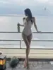 Nuevo traje de baño de una pieza para mujer 2026, traje de baño sexy blanco de alta gama para vacaciones, impresionante estilo tailandés para aguas termales, deseo puro