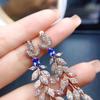 Pendientes de botón de tanzanita natural populares al por mayor de fábrica con incrustaciones de plata S925 Piedra principal 4*6 Ventas directas de fábrica de joyería