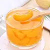 Laranjas frescas em calda de açúcar, caixa fechada, latas grandes comerciais de rodelas de laranja, lanches de frutas prontos para comer