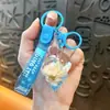 Llavero creativo de concha pequeña con aceite, lindo colgante pequeño de arena movediza líquida, accesorios para bolso, pequeño colgante de regalo, venta al por mayor