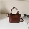 Nova Bolsa Pequena de Textura Trançada Retrô para Comércio Exterior Moda Feminina Bolsa Balde de Textura para Segurar na Mão Bolsa de Ombro Único Transversal para o Dia a Dia Tendência