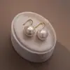 Aguja de Plata S925 Gancho para Oreja de Perla Redonda Luz Amarilla Diseño de Nicho Femenino Sentido Avanzado Pendientes Simples Versátiles Pendientes Explosiones