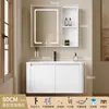 Tocador de baño engrosado y ahorrador de espacio con diseño en color crema, que cuenta con un lavabo redondeado, lavabo cerámico integrado y un lavabo de una sola pieza.