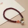 Pulsera de granate natural plata de ley Colgante de caqui bolsa de la suerte Campana nuevo chino simple fresco pulsera de anillo único
