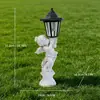 Adorno de artesanía de resina de tres querubines ángeles retro transfronterizo para decoración de caminos de jardín, luz nocturna alimentada por energía solar