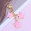 Colgante llavero de flor de color ins transfronterizo creativo diy aleación flor pequeña de doble cara decoración de bolsa para set de audífonos