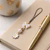 Colgante de correa para teléfono estilo coreano y japonés transfronterizo, estilo ins femenino, con margarita y lazo, cordón fresco y moderno para mujer