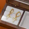 Brincos de temperamento com banho de ouro real design de nicho feminino alto senso brincos de cruz cravejados com zircônia fivela de orelha transfronteiriça atacado