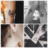 Un juego de 30 pegatinas de tatuaje tatuaje de agua pegatinas de tatuaje para hombres y mujeres realistas pequeños frescos estrellas sánscrito
