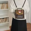 Mochila nicho fresco caricatura 2026 mochila para ir al trabajo nuevo estilo femenina lindo estilo pequeño versión coreana escolar estampado de leopardo moda
