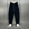 Outono 2026 Novo Calça Esportiva Harem Solta Jovem Bonita Masculina Estilo Americano com Patchwork e Design Plissado